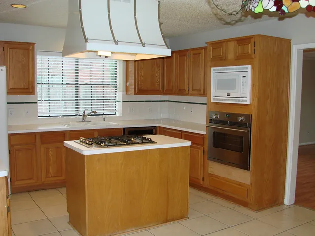 a kitchen with a stove and a microwave