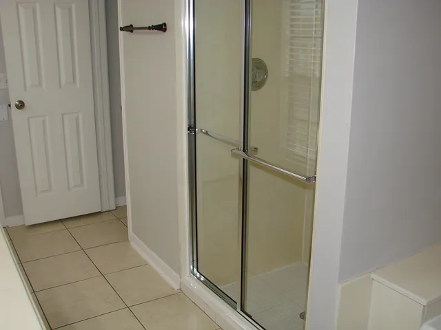 a bathroom with a glass shower door