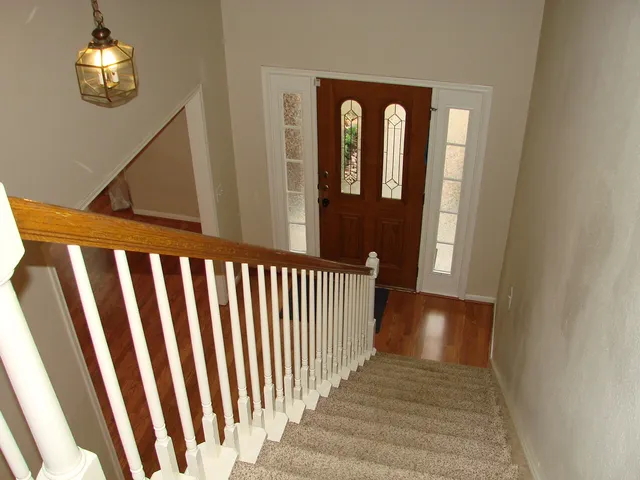 a view of a porch with wooden floor and stairs
