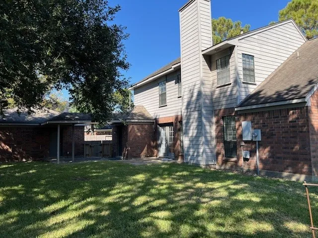 a view of a house with a yard and sitting area