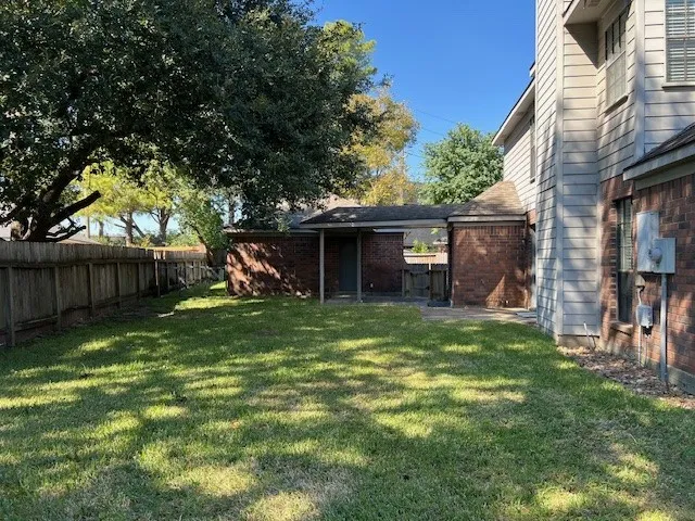 a front view of a house with a garden and trees