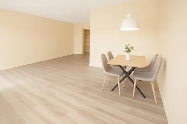 a view of a room with a table and chairs