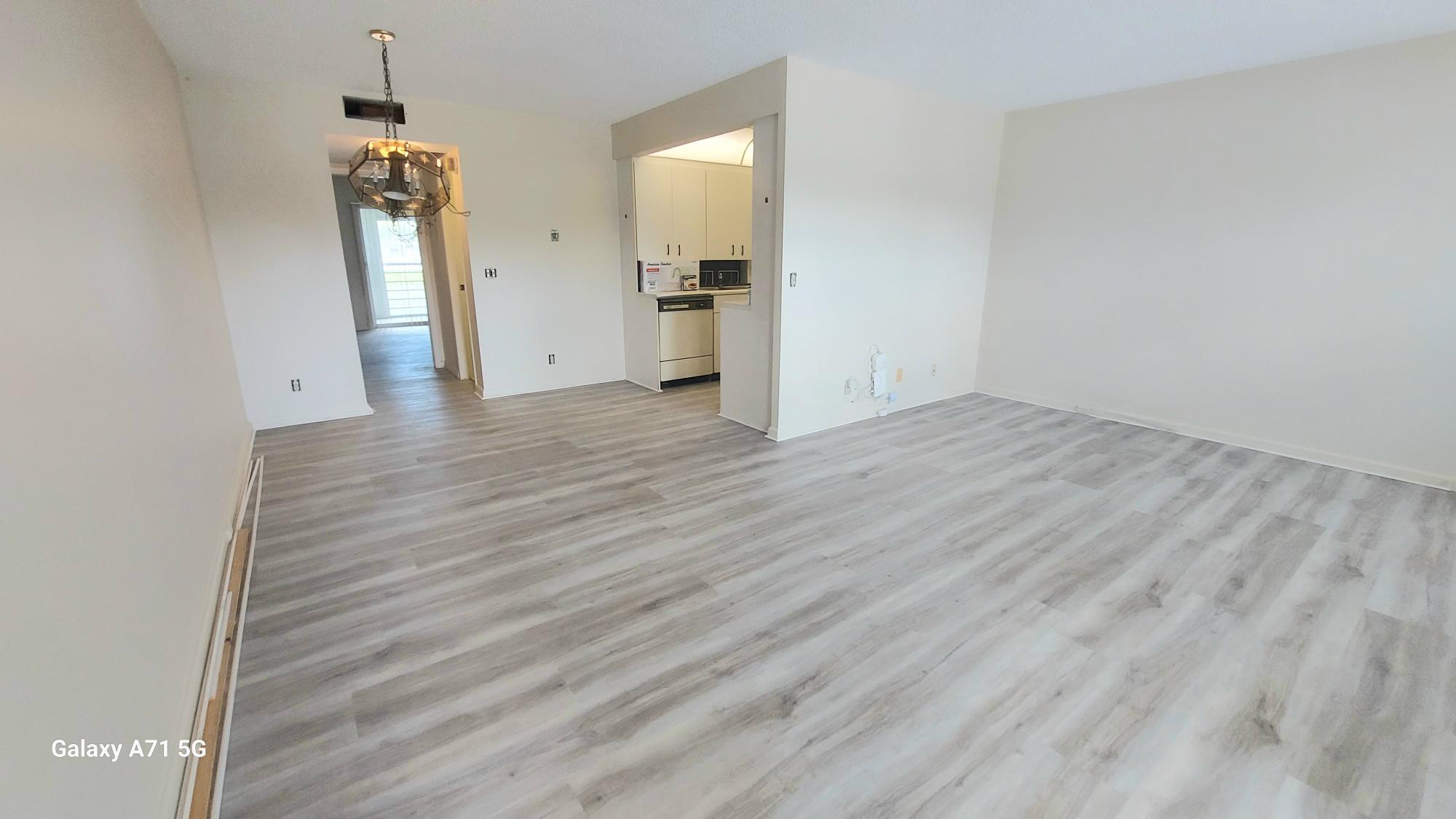 2069 Yarmouth C, Unit 2069 Boca Raton, FL 33434 - Photo 3 of 33 wooden floor in an empty room
