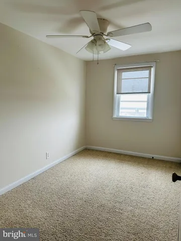 a view of room with a ceiling fan