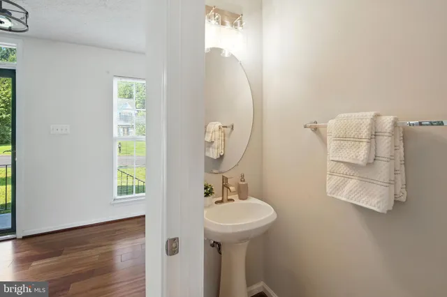 a bathroom with a sink a mirror and a window