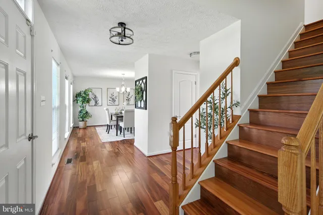 a view of entryway and hall with wooden floor