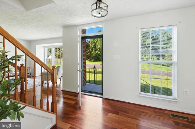 a living room with furniture a dining table and a potted plant