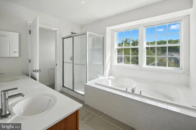 a view of an empty room with chandelier and a window
