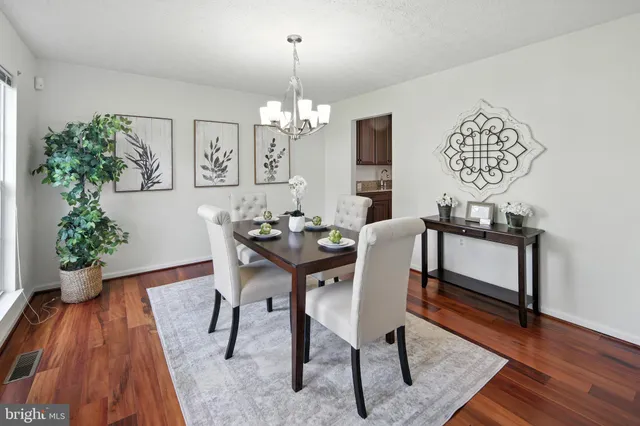 a view of a dining room with furniture wooden floor and chandelier