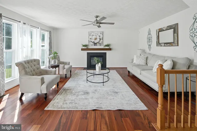 a living room with furniture a chandelier and a fireplace