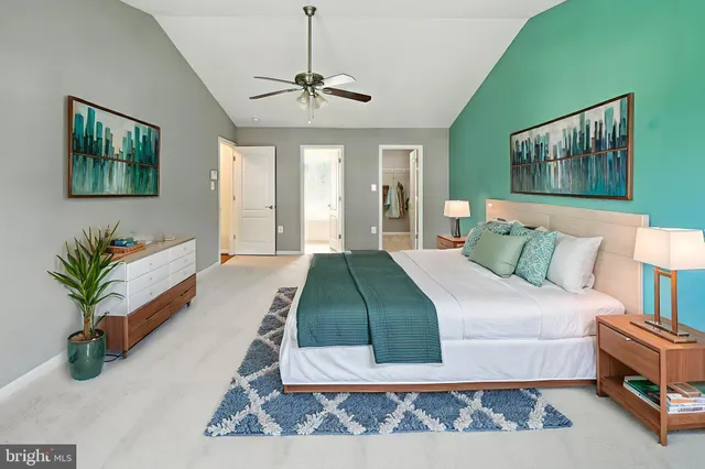 a bedroom with a large bed and a chandelier