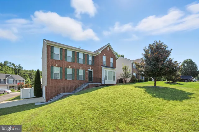 a view of a big building with a big yard and plants