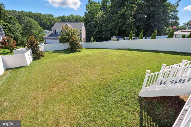 a view of a swimming pool with an outdoor seating and a yard