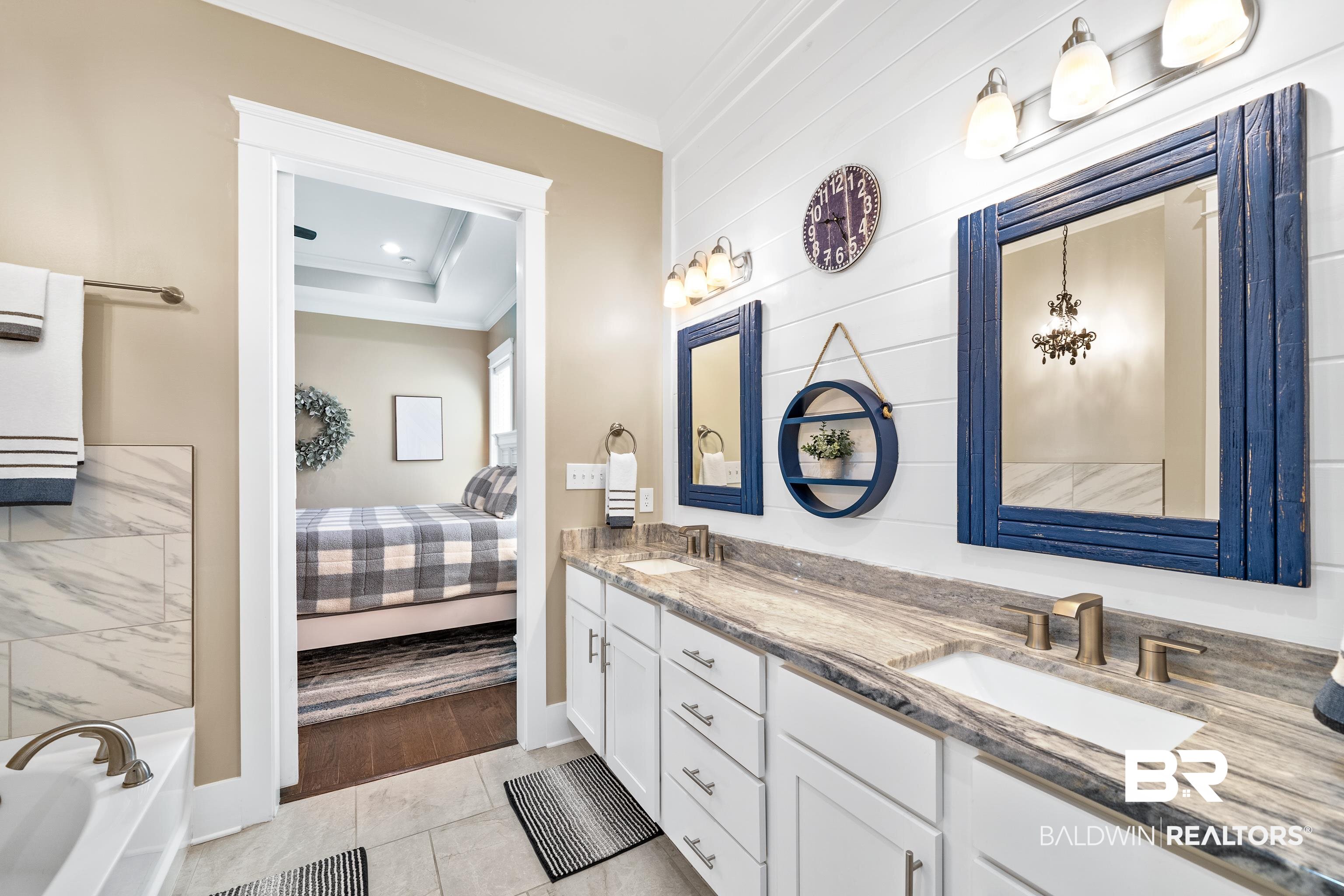 1018 Snapdragon Lane Foley, AL 36535 - Photo 27 of 37 Bathroom featuring vanity, a raised ceiling, crown molding, tile patterned flooring, and a washtub