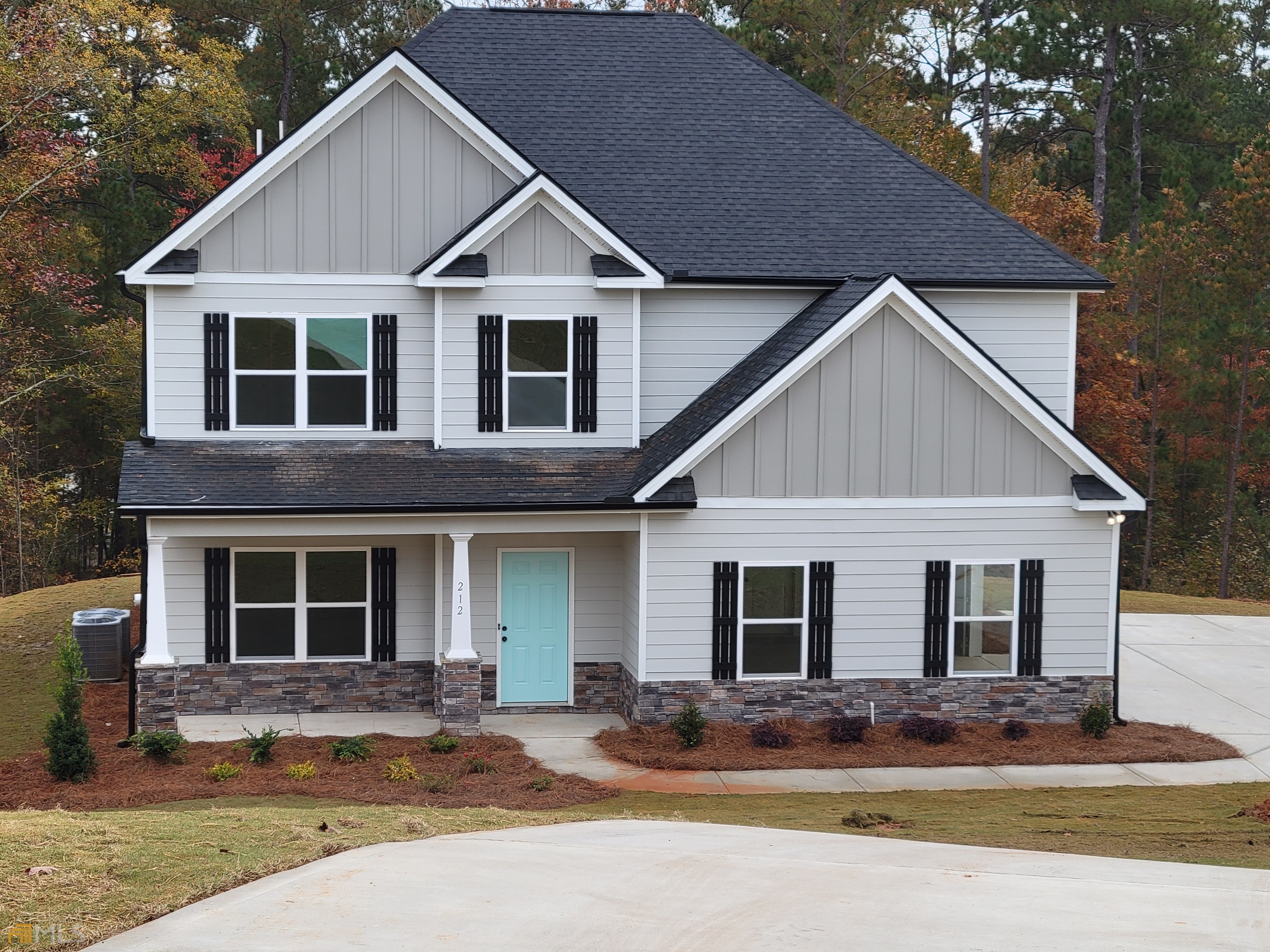 212 River Point Road, Unit 10 Jackson, GA 30233 - Photo 1 of 1 a view of a house with a yard and large tree