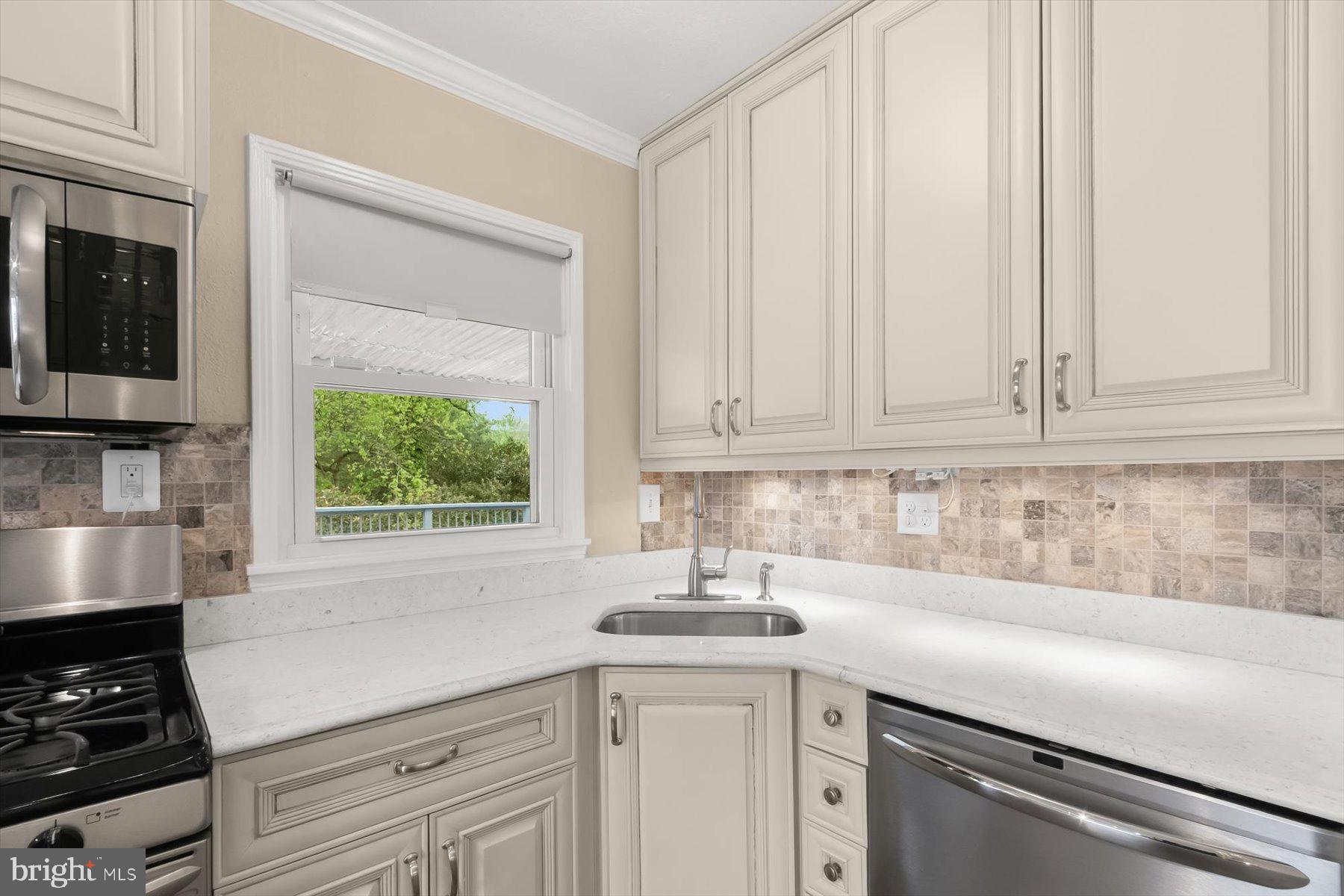 3105 Fayette Road Kensington, MD 20895 - Photo 22 of 93 a kitchen with stainless steel appliances granite countertop white cabinets and a window