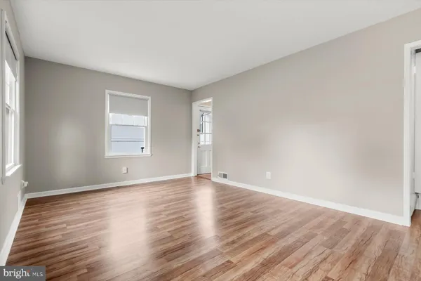 a view of an empty room and wooden floor