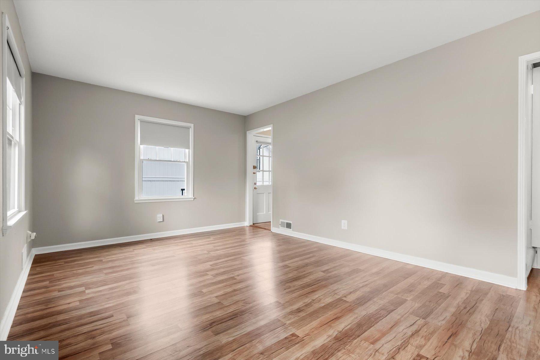 3105 Fayette Road Kensington, MD 20895 - Photo 8 of 93 a view of an empty room with wooden floor and a window