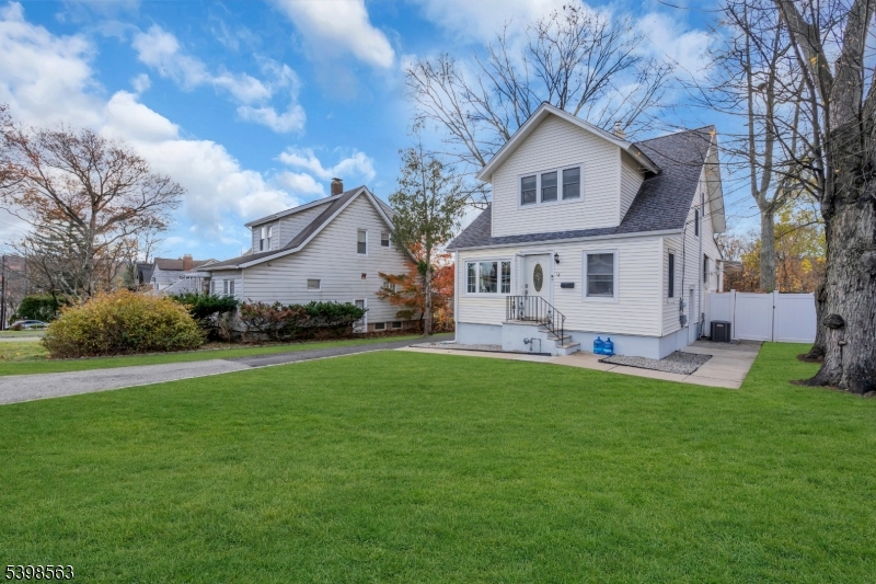 18 Belle Terre Road West Orange, NJ 07052 - Photo 2 of 23 a front view of a house with a garden and trees