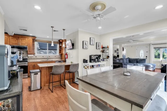 a kitchen with stainless steel appliances granite countertop sink stove top oven and cabinets