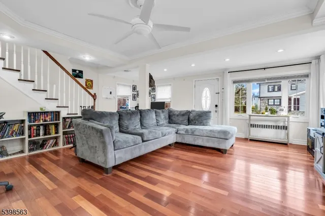 a living room with furniture and a book shelf