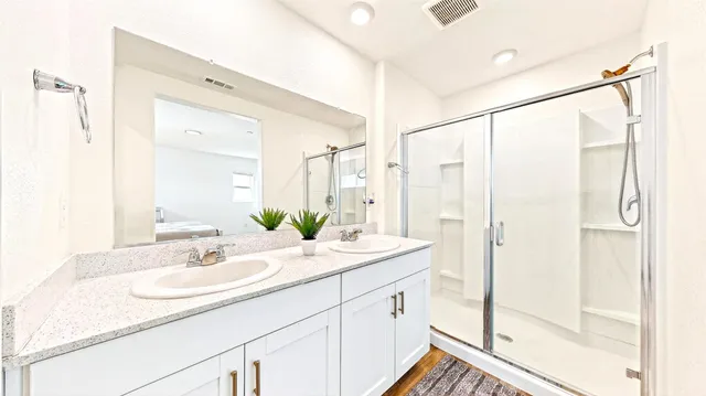 a bathroom with a sink double vanity and a mirror