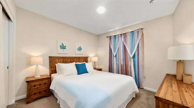 a bedroom with a bed and a night stand