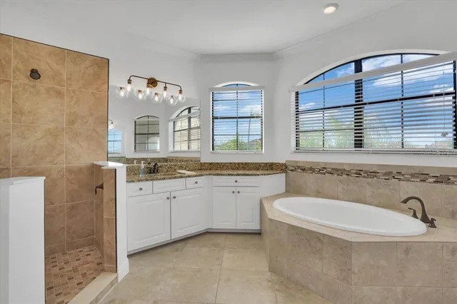 a bedroom with a bed and ceiling fan