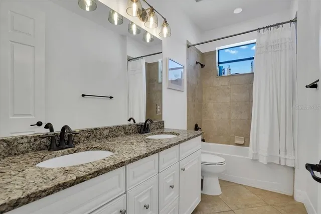 a view of a hallway with wooden floor and windows