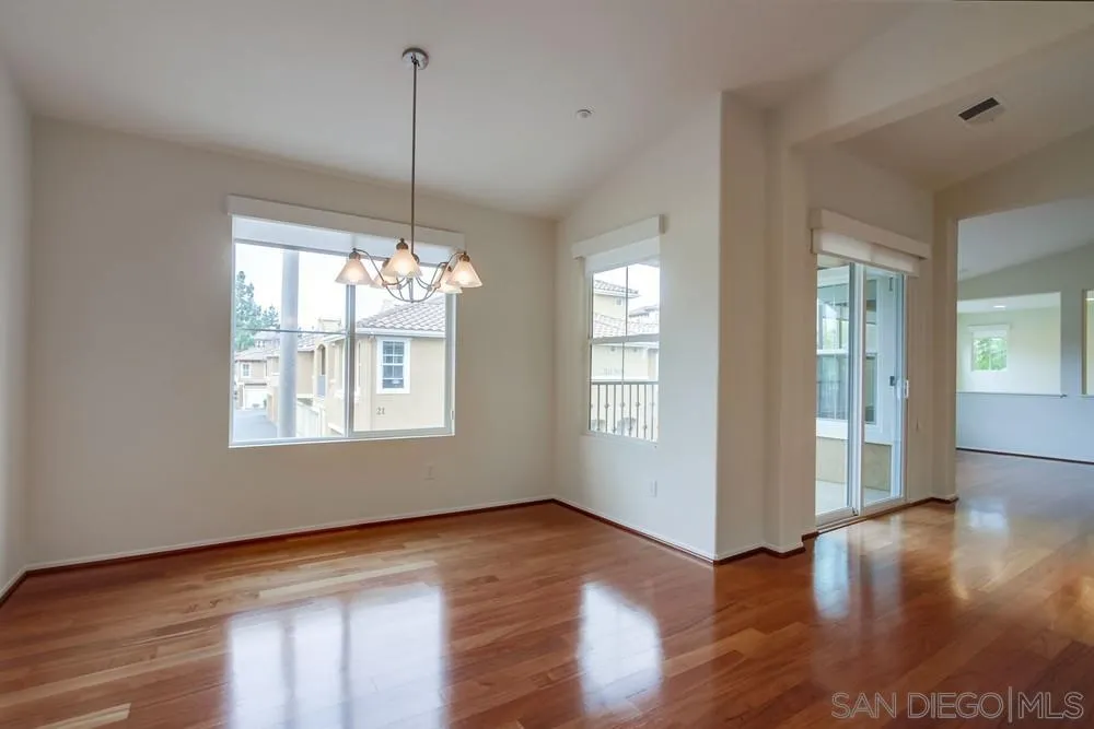 1631 Avery Road San Marcos, CA 92078 - Photo 16 of 32 a view of an empty room with wooden floor and a window