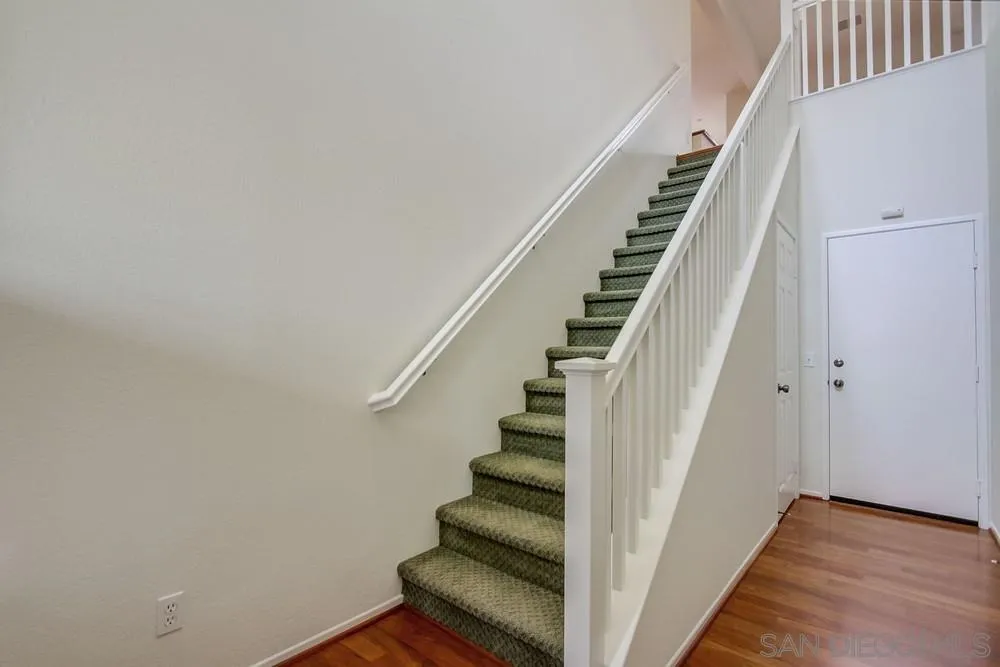 1631 Avery Road San Marcos, CA 92078 - Photo 4 of 32 a view of staircase with wooden floor and white walls