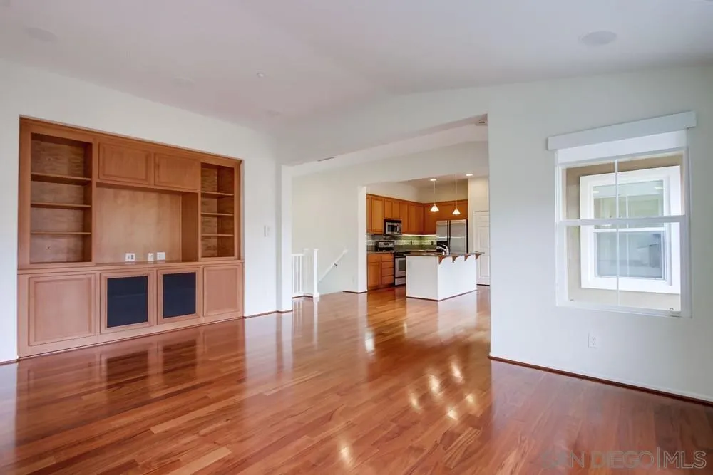 1631 Avery Road San Marcos, CA 92078 - Photo 7 of 32 a view of an empty room with window and wooden floor