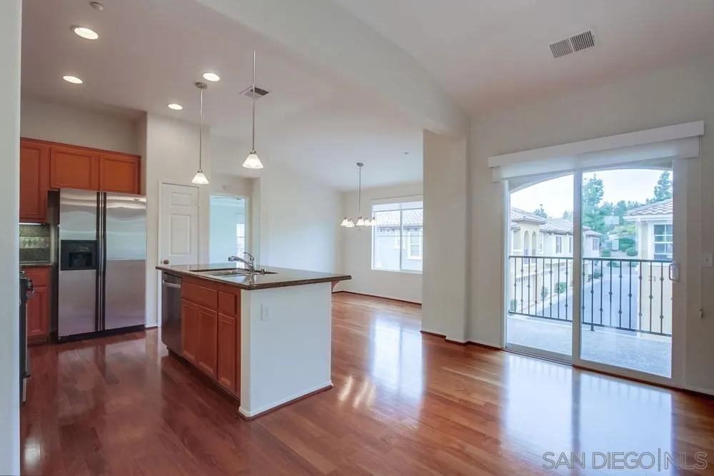 1631 Avery Road San Marcos, CA 92078 - Photo 10 of 32 a large kitchen with granite countertop a large counter top a sink stainless steel appliances and cabinets
