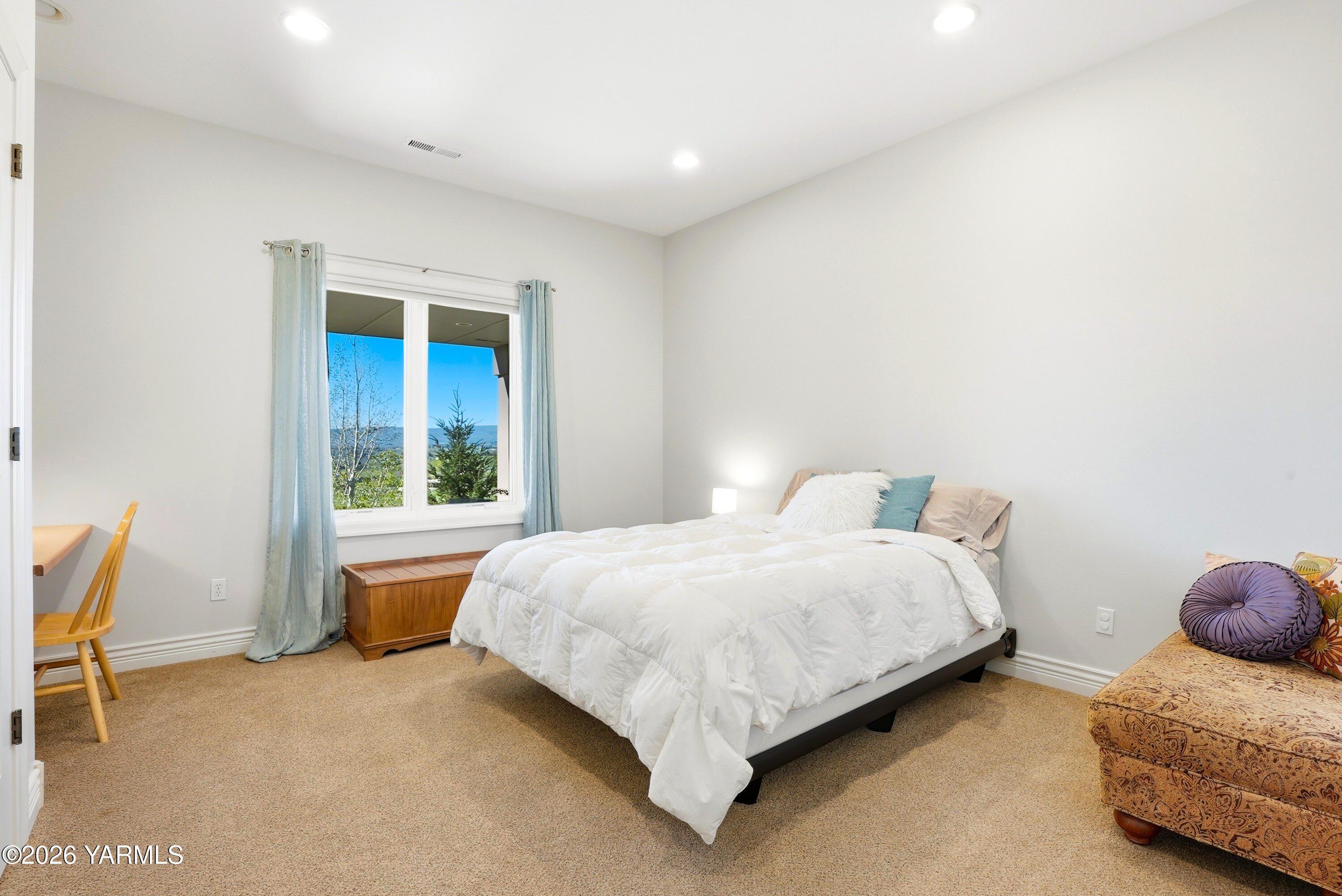 660 Noble Hill Road Yakima, WA 98908 - Photo 38 of 63 a large bed sitting in a room next to a window and a chair