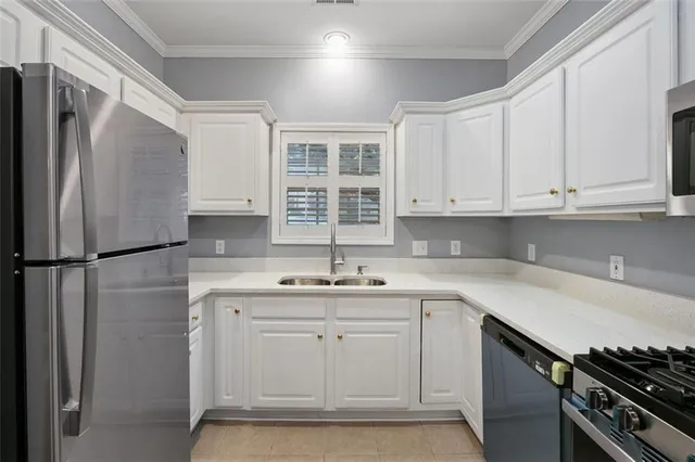 a kitchen with a sink appliances and cabinets
