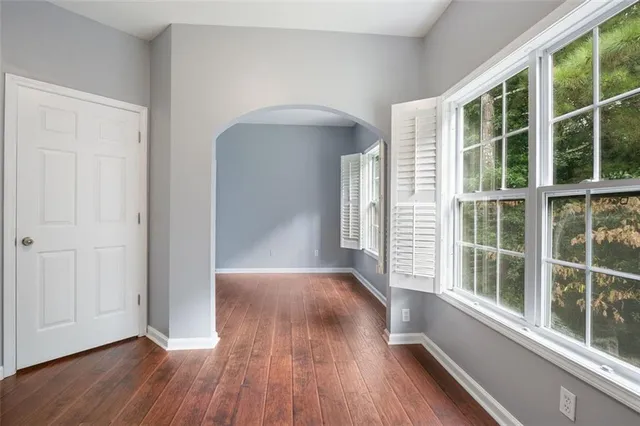 a view of a room with wooden floor and windows