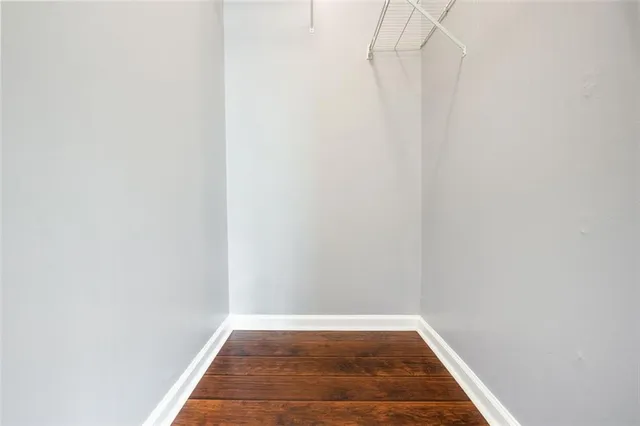a view of a room with wooden floor and white walls