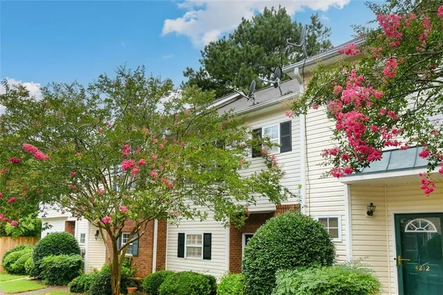 a front view of a house with plants