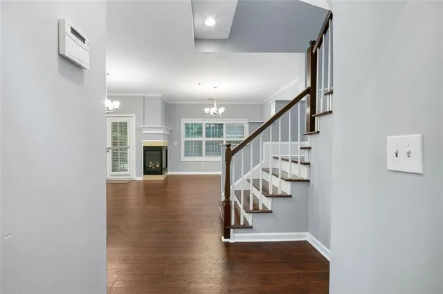 a view of entryway and hall with wooden floor