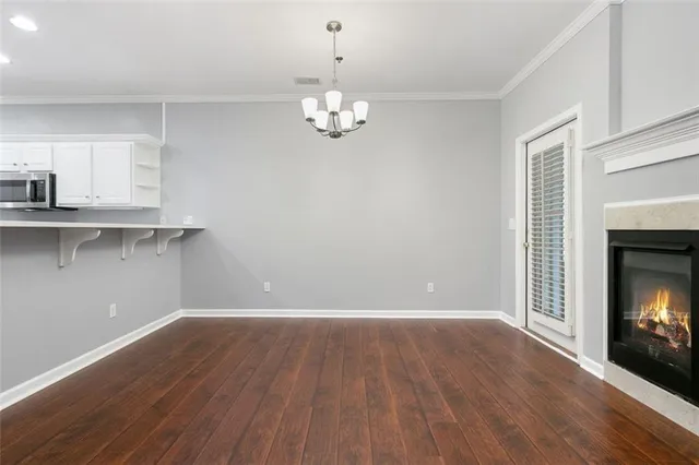 a view of a room with wooden floor and fire place