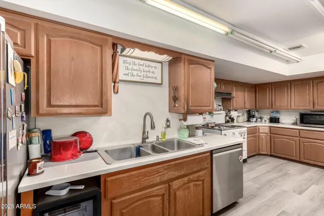 a kitchen with a sink cabinets and window