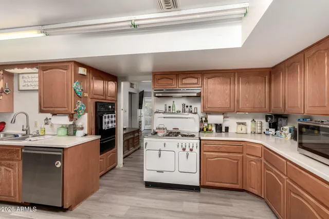 a kitchen with stainless steel appliances a sink stove and cabinets