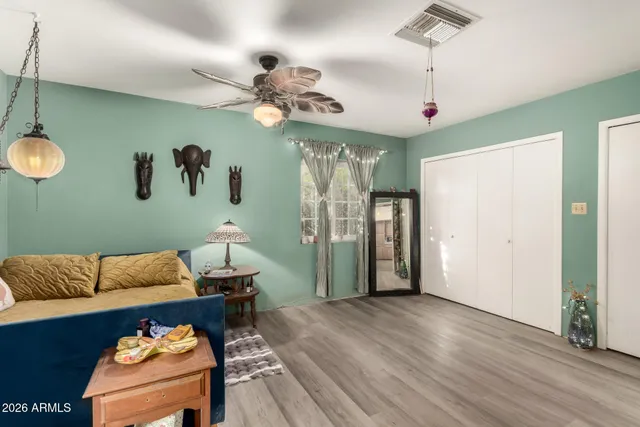 a living room with furniture and wooden floor