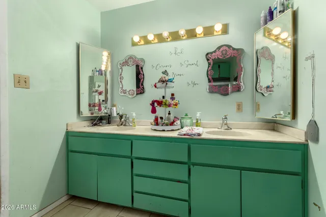 a bathroom with a sink vanity and a mirror