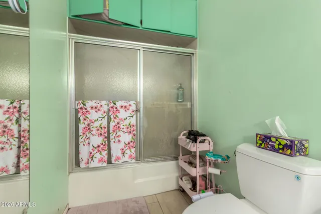 a white toilet sitting next to a bathroom sink