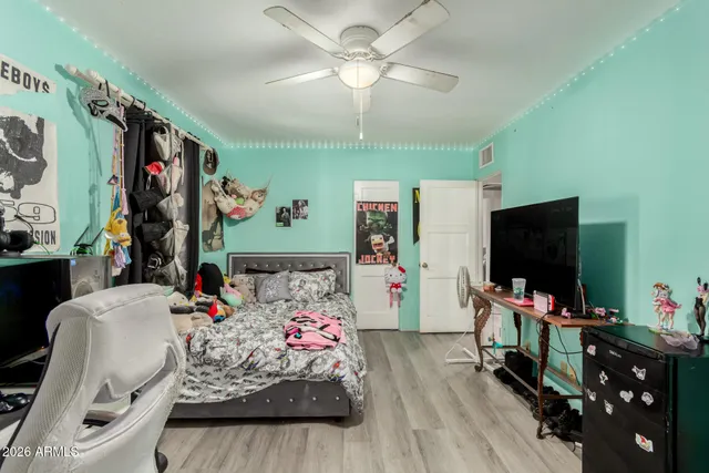 a bedroom with furniture and a flat screen tv