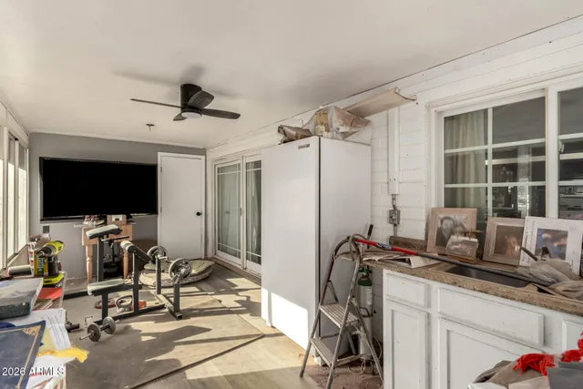 a view of a workspace with furniture and a flat screen tv
