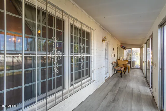 a view of a balcony with chair and wooden floor
