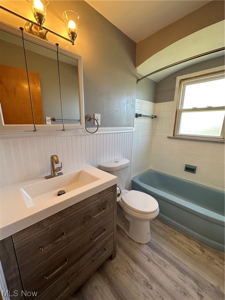 20626 Centuryway Road Maple Heights, OH 44137 - Photo 10 of 15 Full bathroom with tiled shower / bath combo, new vanity, toilet, and new LVP flooring