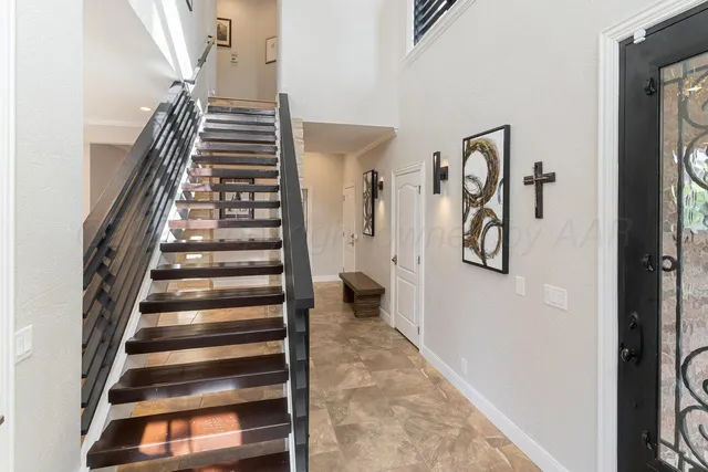 a living room with furniture large window and a fireplace